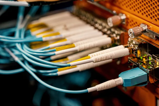 From above of optical switch equipment with many similar connectors with rubber cables and metal parts. Lead generation networks 2027: five scenarios, not trends