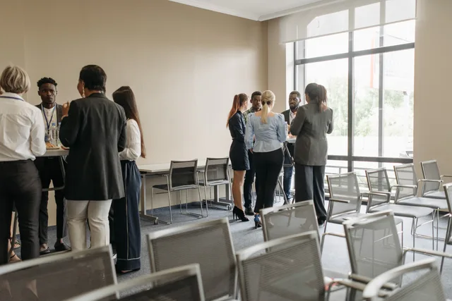 Professionals engaging in a casual networking session during a business conference. Researching rival lead networks without personal data shortcuts