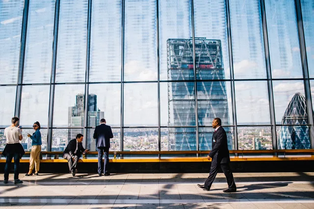 Business professionals in a modern office against a London skyline view. Six quality gates for a lead network, from provenance to advertising