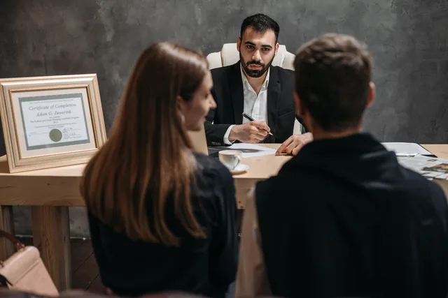 A business meeting with a professional advisor discussing documents in an office. Selecting a lead network with recovery and exit proven before signature